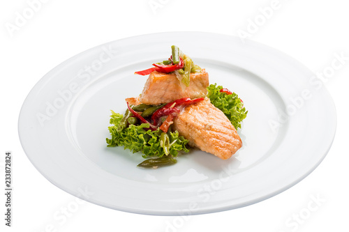 Fillet of baked salmon with salad. On a white background