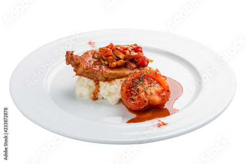 Chicken fillet in sweet and sour sauce with rice and vegetables. On a white background