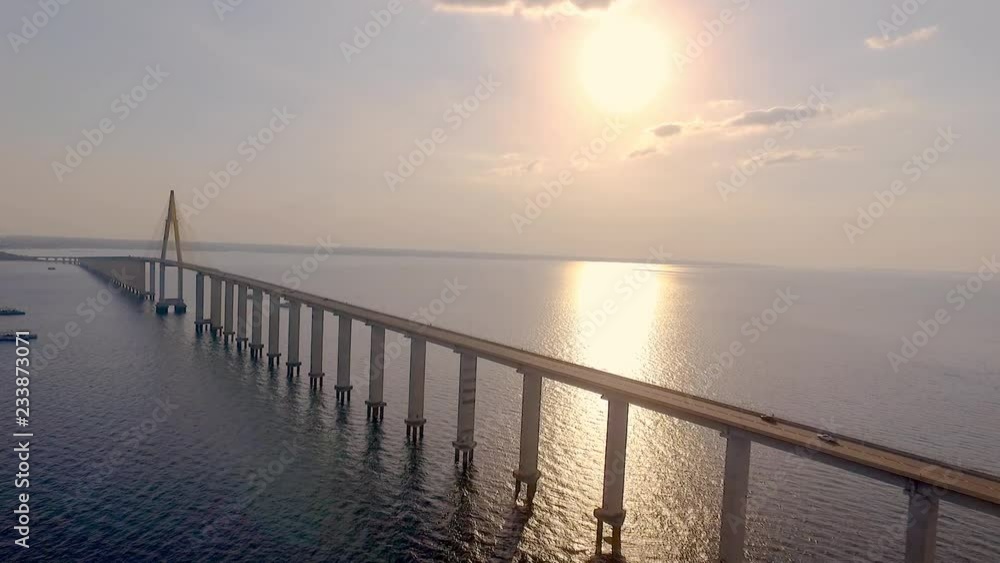 Cable-stayed bridge over the Rio Negro, in Manaus, the largest city in the middle of the Amazon Forest. Filmed by drone, with a beautiful golden sunset in the background. 7/11 Cable-stayed bridge over the Rio Negro, in Manaus, the largest city in the middle of the Amazon Forest. Filmed by drone, with a beautiful golden sunset in the background. 7/11