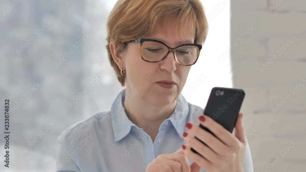 Old Woman in Shock while Using Smartphone Old Woman in Shock while Using Smartphone