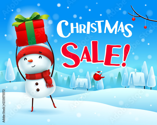 Christmas Sale! Cheerful snowman holds up gift present in Christmas snow scene winter landscape.