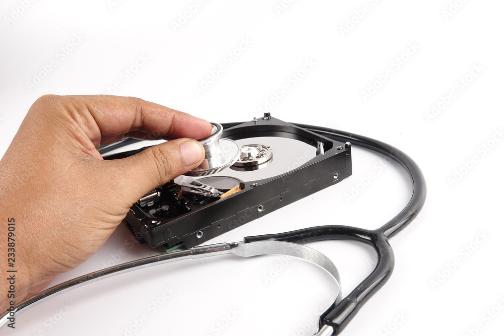 RECOVERY AND REPAIR TECHNOLOGY CONCEPT: Hard Disk Drive (HDD) with stethoscope isolated on white. RECOVERY AND REPAIR TECHNOLOGY CONCEPT: Hard Disk Drive (HDD) with stethoscope isolated on white.
