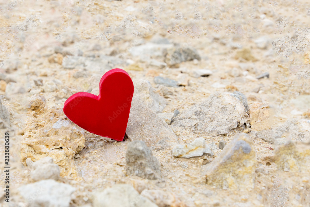Fototapeta premium Red heart on a background of stones.
