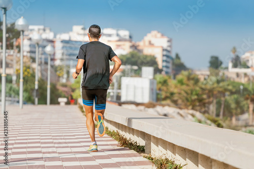Fototapeta Naklejka Na Ścianę i Meble -  healthy lifestyle sports person running along seaside