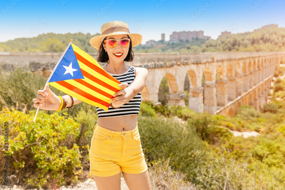 Happy young traveler woman enjoying view of roman Aqueduct Pont del Diable near Tarragona