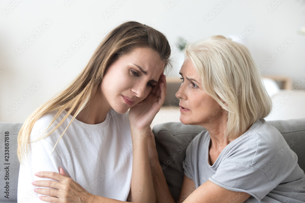 Loving worried older mother comforting sad adult grown daughter, understanding senior mum consoling crying young woman being friend helping with problem, care, empathy support in two age generations Loving worried older mother comforting sad adult grown daughter, understanding senior mum consoling crying young woman being friend helping with problem, care, empathy support in two age generations