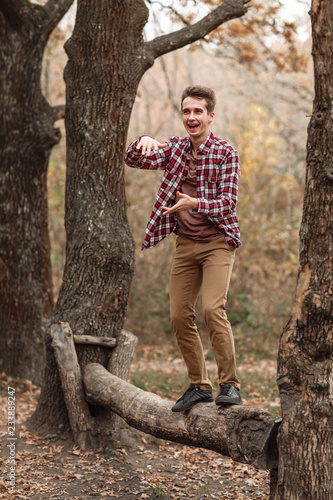 Handsome young guy in nature on an autumn day