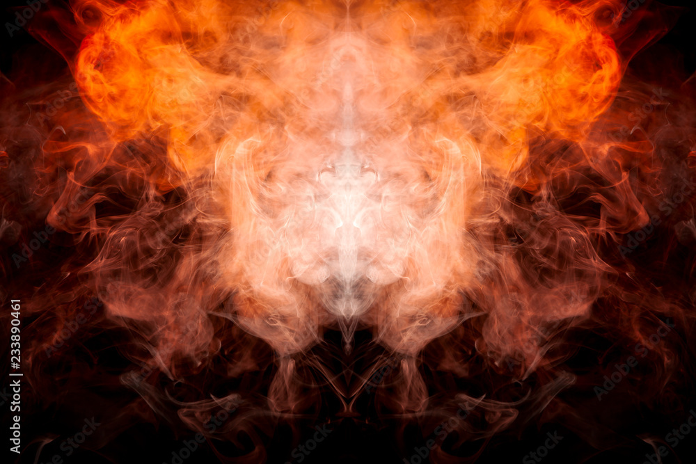 Fototapeta premium A background of orange and yellow wavy smoke in the shape of a ghost's head or a man of mystical appearance on a black isolated ground. Bright abstract pattern of steam from vape.