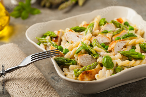 Italian pasta fusilli. Salad with chicken and asparagus in Béchamel sauce.
