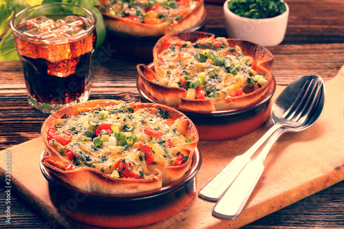 Spinach casserole bake with cheese and tomato on wooden background