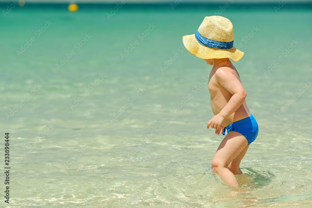 Two year old toddler playing on beach Two year old toddler playing on beach