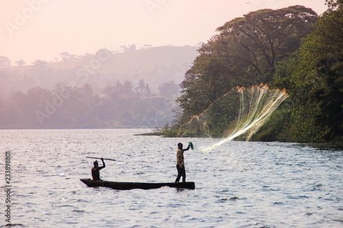 Fisherman throws a net in Lake Victoria.