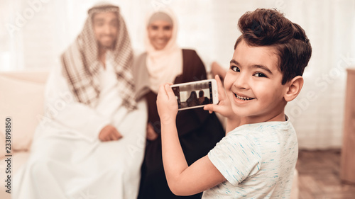 Arabian Boy Taking Photo of Happy Family at Home.