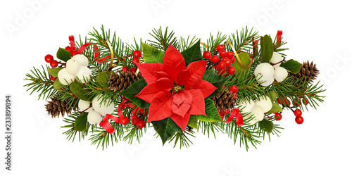 Fototapeta Naklejka Na Ścianę i Meble -  Twigs of Christmas tree, poinsettia flower, berries and holiday decorations in arrangement