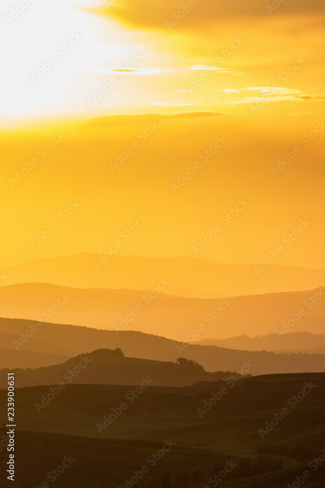 Fototapeta premium Sunset with shades in a rolling landscape