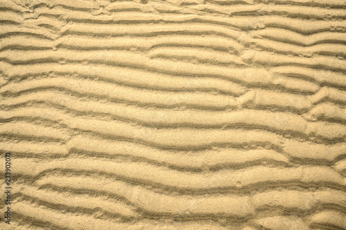 natural pattern rippled yellow sand on the beach or in the desert, background, texture