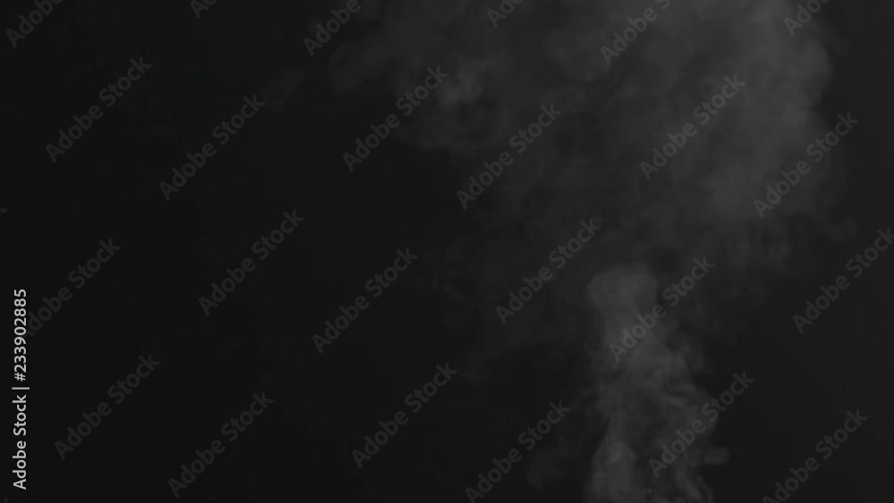 Slow motion closeup vapor stream rises from bottom center on black background Slow motion closeup vapor stream rises from bottom center on black background