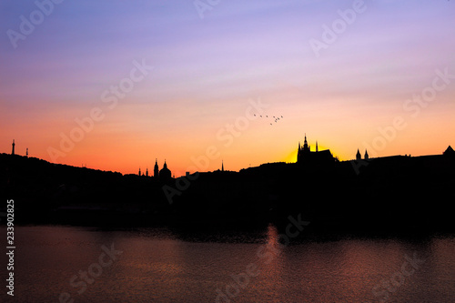Prague, Bohemia, Czech Republic. Sunset glow view of the Prague castle in twilight and silhouette. © plusminus20