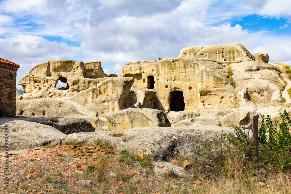 Beautuful View to Ancient Orthodox Church in mount in antique cave city Uplistsikhe. The Uplistsikhe 9th-10th century three-nave basilica and vale of Mtkvari river, Shida Kartli, Gori, Georgia