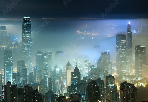 Photography foggy night view of Victoria harbor in Hong Kong city