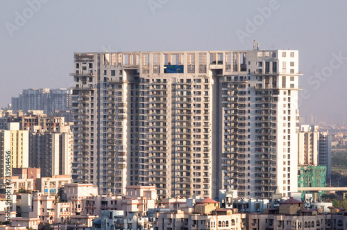 Aerial shot of skyscraper, houses, buildings in noida, gurgaon, delhi, bangalore, hyderabad, jaipur, lucknow. The growing cities housing offices are all moving higher up