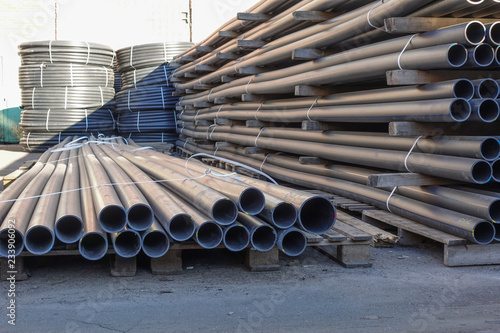 Plastic pipes in stock of finished products stacked in packs photo