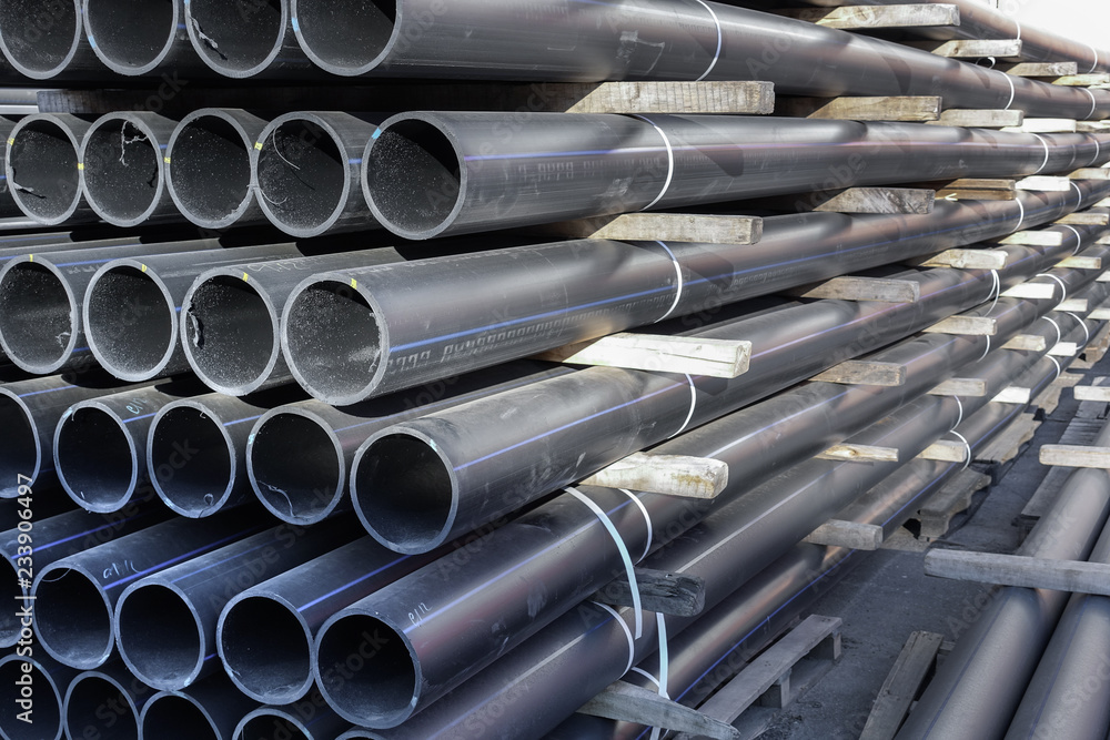 Fototapeta premium Plastic pipes in stock of finished products stacked in packs