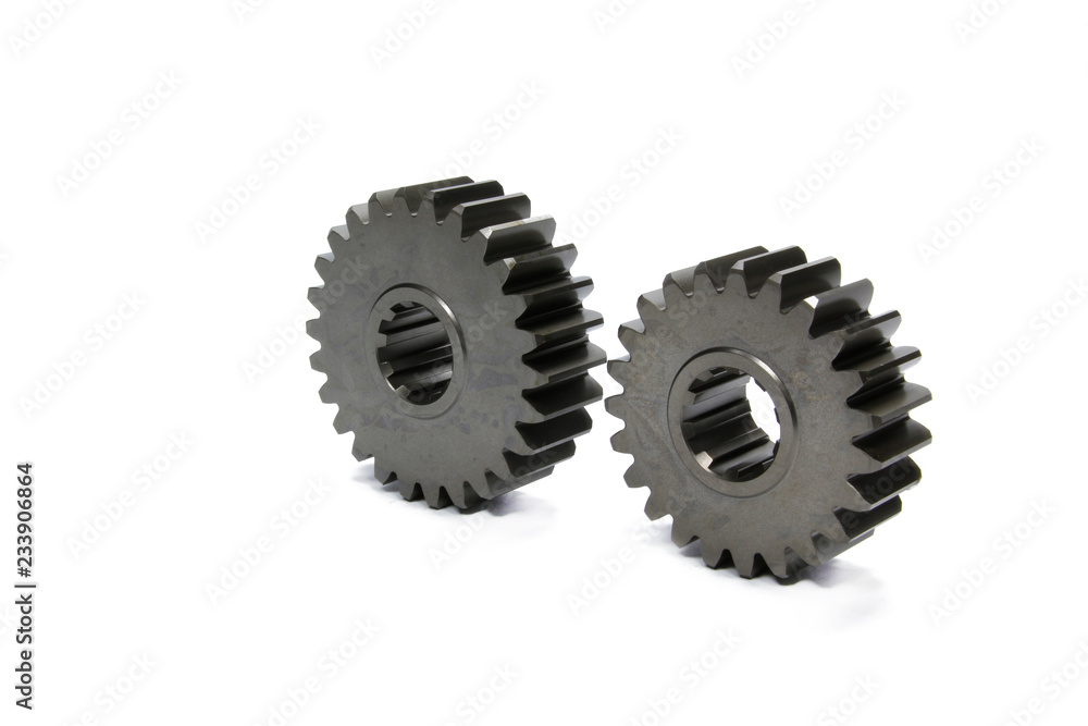 Metal gears isolated above white background. Car parts on white background. Metal gears isolated above white background. Car parts on white background.