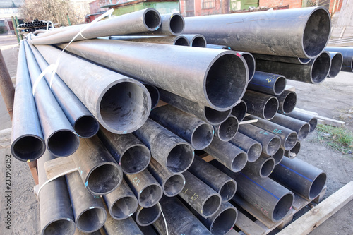 Old plastic pipes of various sizes and diameters photo