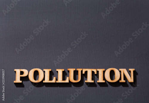 Word pollution in wooden letters. Wooden background