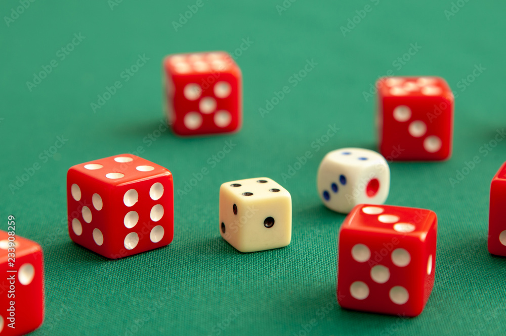 Red dices on green poker gaming table in casino. Concept online gambling Red dices on green poker gaming table in casino. Concept online gambling