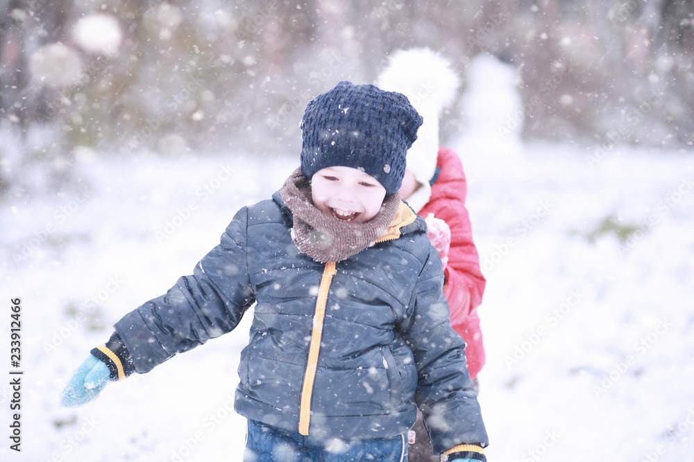 Kids walk in the park first snow