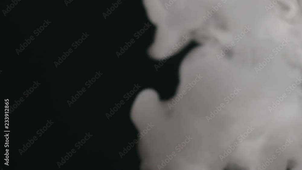 Slow motion closeup vapor stream from right on black background Slow motion closeup vapor stream from right on black background