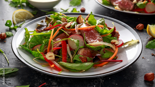 Spicy Beef Salad with Carrots, radish, bean sprouts, chilli, nuts and green mix