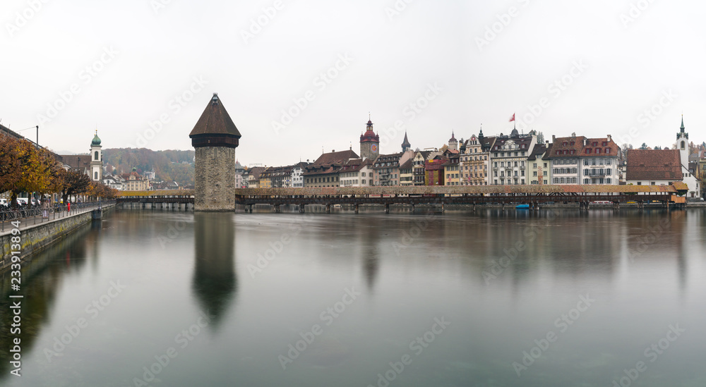 Lucerne, LU / Switzerland - November 9, 2018: the famous Swiss city of Lucerne cityscape skyline and Kappel bridge with water tower panorama view long exposure