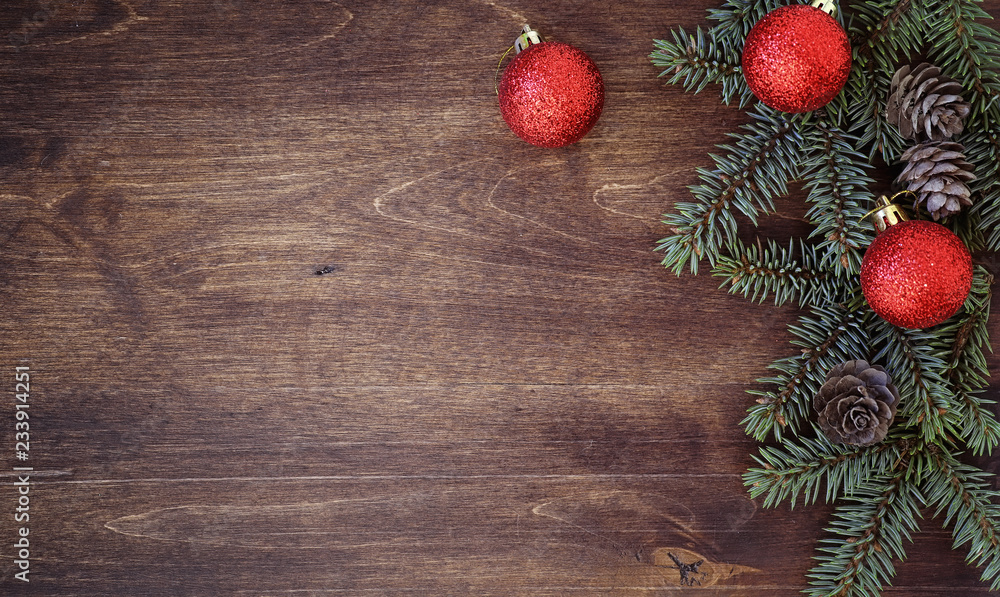 New Year's background. Spruce branches on a wooden table. Ornaments for the New Year tree. Christmas concept. New Year's background. Spruce branches on a wooden table. Ornaments for the New Year tree. Christmas concept.