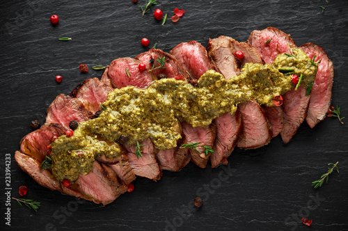 Картината върху платно Medium rare venison steak with green pesto sauce and pepper