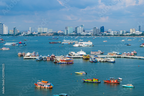 The view of the scenery is filled with the beauty of the sea, the sky and many ships that park in the bay and the city.