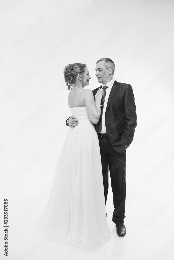 Wedding couple on the nature is hugging each other. Beautiful model girl in white dress. Man in suit. Beauty bride with groom. Female and male portrait. Woman with lace veil. Lady and guy outdoors Wedding couple on the nature is hugging each other. Beautiful model girl in white dress. Man in suit. Beauty bride with groom. Female and male portrait. Woman with lace veil. Lady and guy outdoors