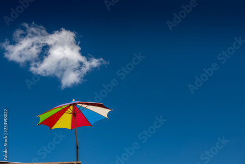 Colorful umbrella with blue sky.