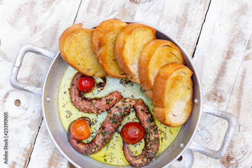 delicious octopus grilled with toasts top view