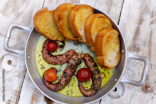 delicious octopus grilled with toasts top view