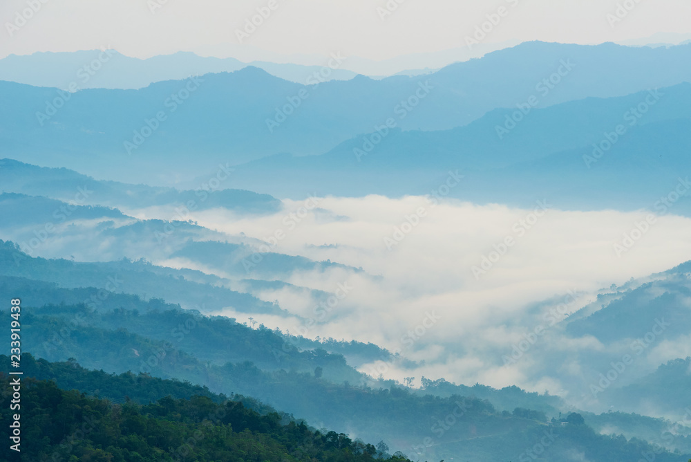 Layer of rainforest hills and morning fog over the valley in Borneo