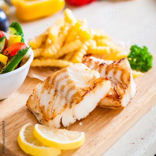 Fish dish - fried fish fillet with vegetables and french fries