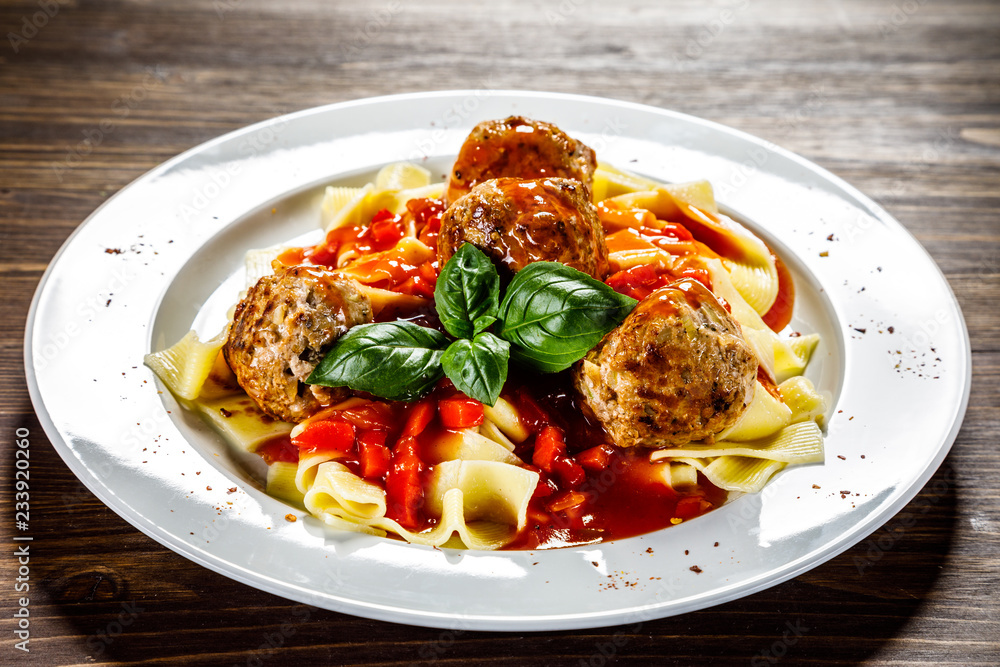 Pasta with meatballs on wooden background Pasta with meatballs on wooden background