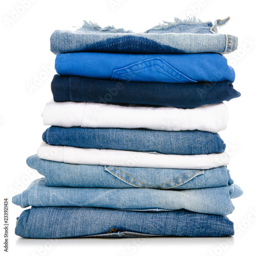 A stack of clothes jeans pants on a white background. Isolation