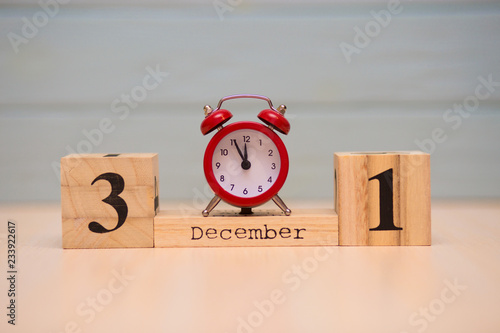 Wallpaper Mural December 31st set on wooden calendar and red alarm clock with blue background. Torontodigital.ca