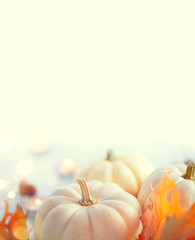 Thanksgiving background. Holiday scene. Wooden table, decorated with pumpkins, autumn leaves and candles. Vertical image