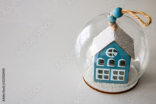 House in a glass ball on white background