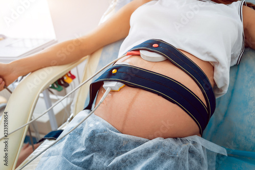 Canvas Print Pregnant woman with electrocardiograph check up for her baby